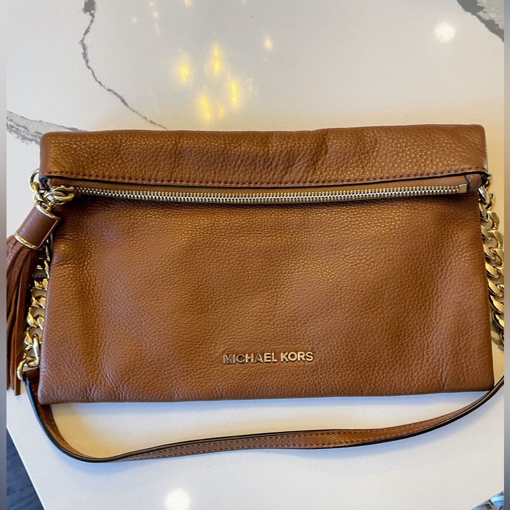 Michael Kors tan clutch/ shoulder bag with gold hardware and tassel